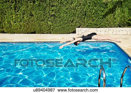 Mature woman diving into swimming pool View Large Photo Image Stock Photo - Mature woman diving into swimming pool. Fotosearch