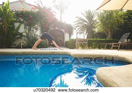 Mature woman doing yoga at holiday apartment poolside View Large Photo Image Stock Image - Mature woman doing yoga at holiday apartment poolside. Fotosearch