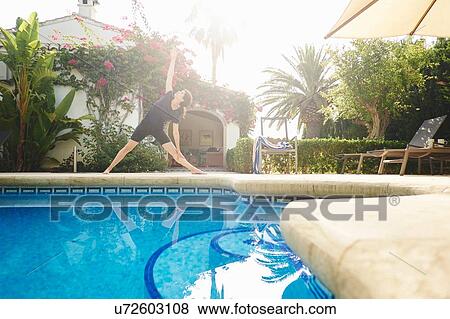 Mature woman doing yoga at poolside holiday apartment View Large Photo Image Stock Photo - Mature woman doing yoga at poolside holiday apartment. Fotosearch