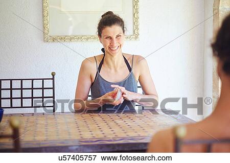 Mature woman shuffling playing cards at patio table View Large Photo Image Stock Photo - Mature woman shuffling playing cards at patio table. Fotosearch