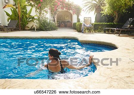 Mature woman swimming in holiday apartment swimming pool View Large Photo Image Stock Photograph - Mature woman swimming in holiday apartment swimming pool. Fotosearch
