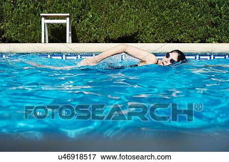 Mature woman swimming in swimming pool View Large Photo Image Stock Photo - Mature woman swimming in swimming pool. Fotosearch