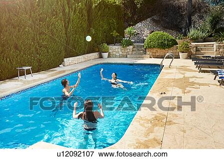 Mature woman throwing ball with son and daughter in swimming pool View Large Photo Image Stock Photo - Mature woman throwing ball with son and daughter in swimming pool. Fotosearch