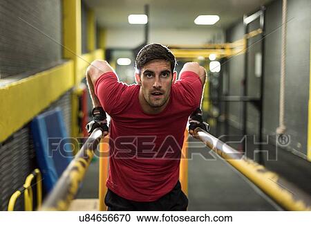 Mid adult man working out at gym View Large Photo Image Stock Image - Mid adult man working out at gym. Fotosearch
