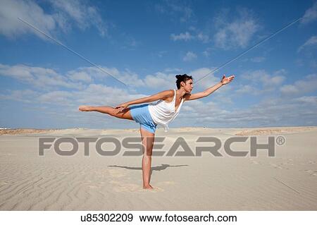 "Mid adult woman practicing yoga on beach, Cape Verde, Africa" View Large Photo Image Stock Photo - "Mid adult woman practicing yoga on beach, Cape Verde, Africa". Fotosearch