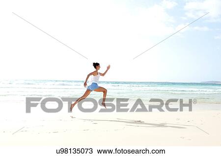 "Mid adult woman running barefoot on beach, Cape Verde, Africa" View Large Photo Image Stock Image - "Mid adult woman running barefoot on beach, Cape Verde, Africa". Fotosearch