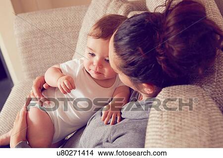 Mother and baby boy playing in living room View Large Photo Image Picture - Mother and baby boy playing in living room. Fotosearch
