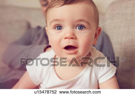 Stock Image - Mother and baby boy playing in living room. Fotosearch
