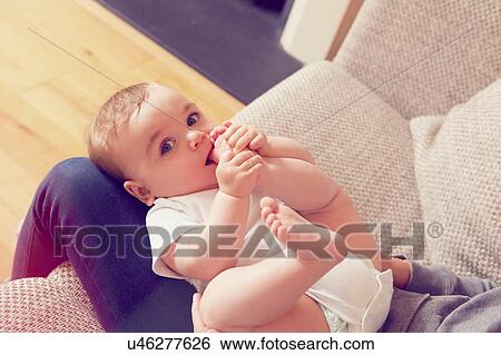 Mother and baby boy playing in living room View Large Photo Image Stock Photograph - Mother and baby boy playing in living room. Fotosearch