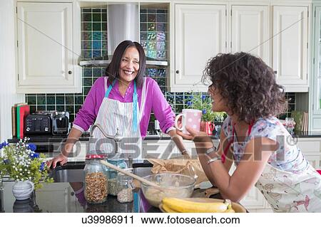 "Mother and grown daughter, cooking in kitchen" View Large Photo Image Stock Image - "Mother and grown daughter, cooking in kitchen". Fotosearch
