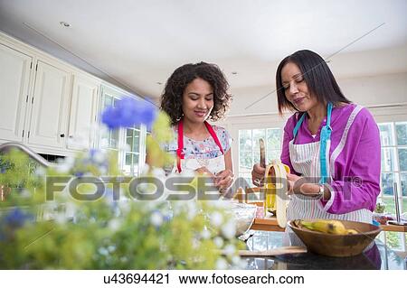 "Mother and grown daughter, cooking in kitchen" View Large Photo Image Stock Image - "Mother and grown daughter, cooking in kitchen". Fotosearch