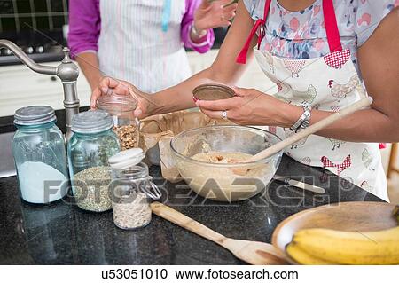"Mother and grown daughter, cooking in kitchen, mid section" View Large Photo Image Stock Image - "Mother and grown daughter, cooking in kitchen, mid section". Fotosearch