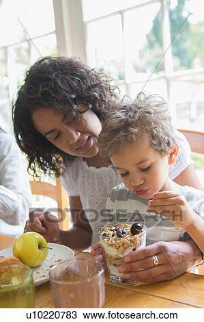 Mother and son eating breakfast together View Large Photo Image Stock Image - Mother and son eating breakfast together. Fotosearch