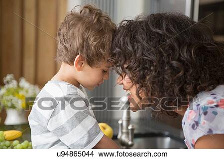 Mother and son in kitchen together View Large Photo Image Picture - Mother and son in kitchen together. Fotosearch