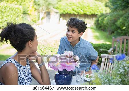 Stock Photo - "Mother and son, sitting in garden". Fotosearch