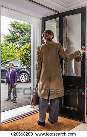 Stock Image - Mother getting son ready for school. Fotosearch