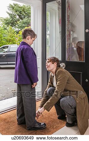 Mother getting son ready for school View Large Photo Image Stock Photo - Mother getting son ready for school. Fotosearch