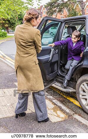 "Mother on school run, opening car door for son" View Large Photo Image Stock Photo - "Mother on school run, opening car door for son". Fotosearch