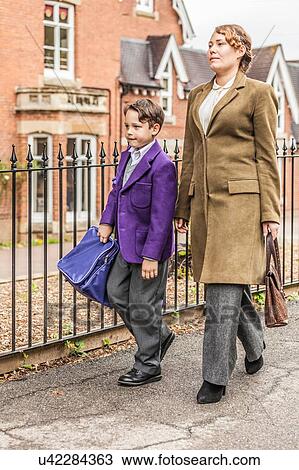 Mother walking son to school View Large Photo Image Stock Image - Mother walking son to school. Fotosearch