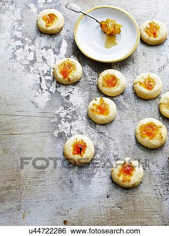 Overhead view of thumbprint cookies and spoonful of marmalade View Large Photo Image Stock Photograph - Overhead view of thumbprint cookies and spoonful of marmalade. Fotosearch