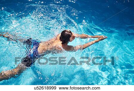 Overhead view of young man swimming in swimming pool View Large Photo Image Stock Photo - Overhead view of young man swimming in swimming pool. Fotosearch