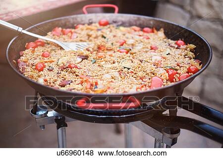 Pan with fresh paella cooking on patio View Large Photo Image Stock Photo - Pan with fresh paella cooking on patio. Fotosearch