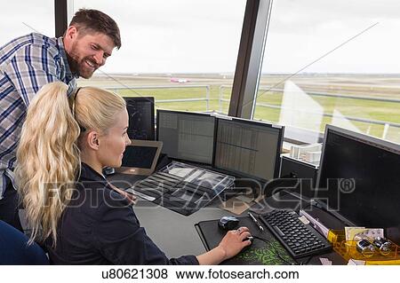Stock Photo - People working in air control tower using computer. Fotosearch