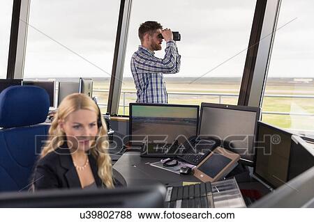 "People working in air traffic control tower, monitoring screens and looking through binoculars" View Large Photo Image Stock Photo - "People working in air traffic control tower, monitoring screens and looking through binoculars". Fotosearch