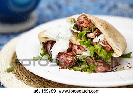 Pita bread stuffed with meat and lettuce View Large Photo Image Stock Photo - Pita bread stuffed with meat and lettuce. Fotosearch
