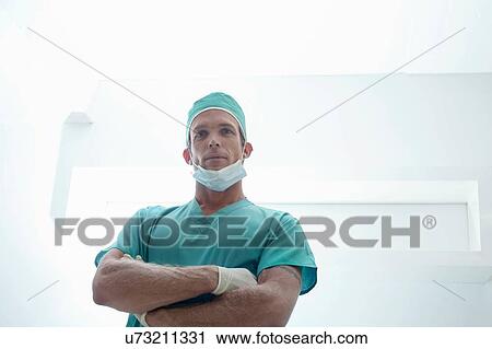 Portrait of confident male surgeon with arms folded wearing surgical scrubs View Large Photo Image Stock Image - Portrait of confident male surgeon with arms folded wearing surgical scrubs. Fotosearch