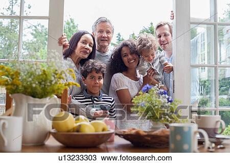 "Portrait of family standing at patio doors, ready for breakfast" View Large Photo Image Stock Image - "Portrait of family standing at patio doors, ready for breakfast". Fotosearch