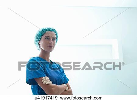 Portrait of female surgeon with arms folded wearing surgical scrubs View Large Photo Image Stock Photo - Portrait of female surgeon with arms folded wearing surgical scrubs. Fotosearch