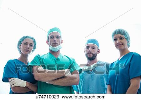 Portrait of four confident male and female surgeons wearing surgical scrubs View Large Photo Image Stock Photo - Portrait of four confident male and female surgeons wearing surgical scrubs. Fotosearch