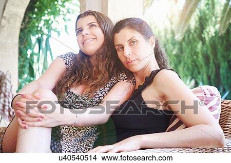 Portrait of mature woman and teenage daughter on patio View Large Photo Image Picture - Portrait of mature woman and teenage daughter on patio. Fotosearch