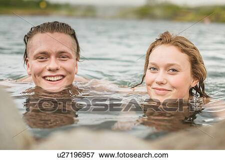 "Portrait of young couple relaxing in Secret Lagoon hot spring (Gamla Laugin), Fludir, Iceland" View Large Photo Image Stock Photo - "Portrait of young couple relaxing in Secret Lagoon hot spring (Gamla Laugin), Fludir, Iceland". Fotosearch