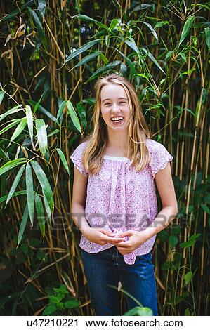 "Portrait of young girl, outdoors, smiling" View Large Photo Image Stock Image - "Portrait of young girl, outdoors, smiling". Fotosearch