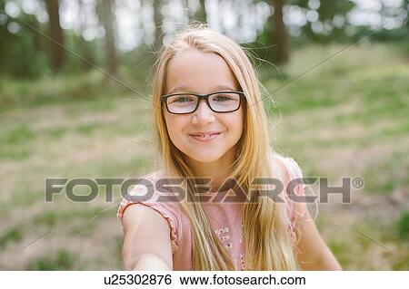 "Portrait of young girl, outdoors, smiling" View Large Photo Image Stock Photograph - "Portrait of young girl, outdoors, smiling". Fotosearch