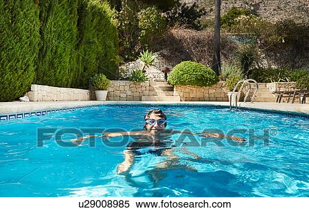 Portrait of young man in swimming pool View Large Photo Image Stock Photography - Portrait of young man in swimming pool. Fotosearch