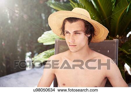 Portrait of young man wearing sunhat View Large Photo Image Picture - Portrait of young man wearing sunhat. Fotosearch
