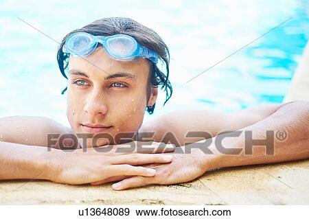 Portrait of young man with wet hair in swimming pool View Large Photo Image Stock Photo - Portrait of young man with wet hair in swimming pool. Fotosearch
