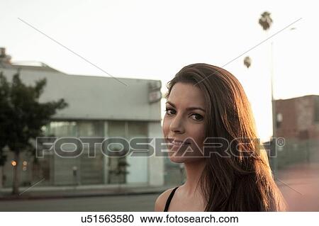 "Portrait of young woman in street, head and shoulders" View Large Photo Image Stock Image - "Portrait of young woman in street, head and shoulders". Fotosearch
