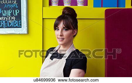 Portrait of young woman working in cake shop View Large Photo Image Stock Photograph - Portrait of young woman working in cake shop. Fotosearch