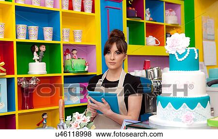 "Portrait of young woman, working in cake shop, stock taking" View Large Photo Image Stock Photo - "Portrait of young woman, working in cake shop, stock taking". Fotosearch