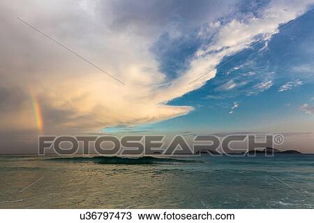"Rainbow over ocean in cloudy sky, Rio De Janerio, Brazil" View Large Photo Image Stock Image - "Rainbow over ocean in cloudy sky, Rio De Janerio, Brazil". Fotosearch