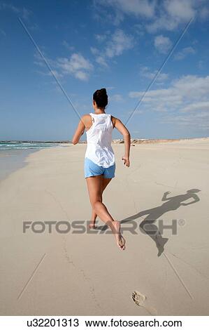 "Rear view of mid adult woman running on beach, Cape Verde, Africa" View Large Photo Image Stock Image - "Rear view of mid adult woman running on beach, Cape Verde, Africa". Fotosearch
