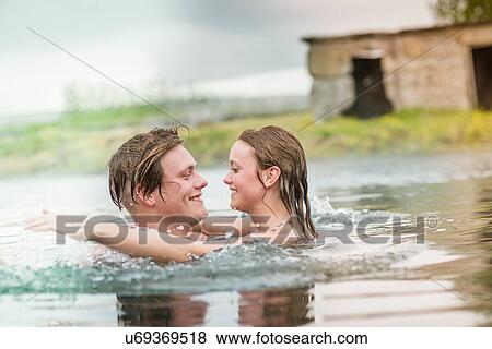 "Romantic young couple splashing in Secret Lagoon hot spring (Gamla Laugin), Fludir, Iceland" View Large Photo Image Stock Photo - "Romantic young couple splashing in Secret Lagoon hot spring (Gamla Laugin), Fludir, Iceland". Fotosearch