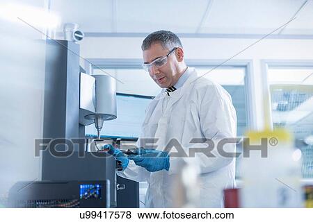 Stock Photo - Scientist uses rheology machine to test graphene ink in graphene processing factory. Fotosearch