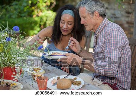 Senior couple eating meal outdoors View Large Photo Image Stock Image - Senior couple eating meal outdoors. Fotosearch