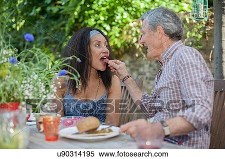 Senior couple eating meal outdoors View Large Photo Image Stock Photography - Senior couple eating meal outdoors. Fotosearch