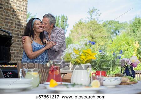 Stock Photo - Senior couple embracing outdoors. Fotosearch